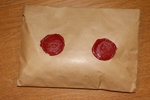 Plomberad förpackning 100 gram klipp från inbetalningskort (postgirot) från PFA, stämplade 1925. Se bild.
